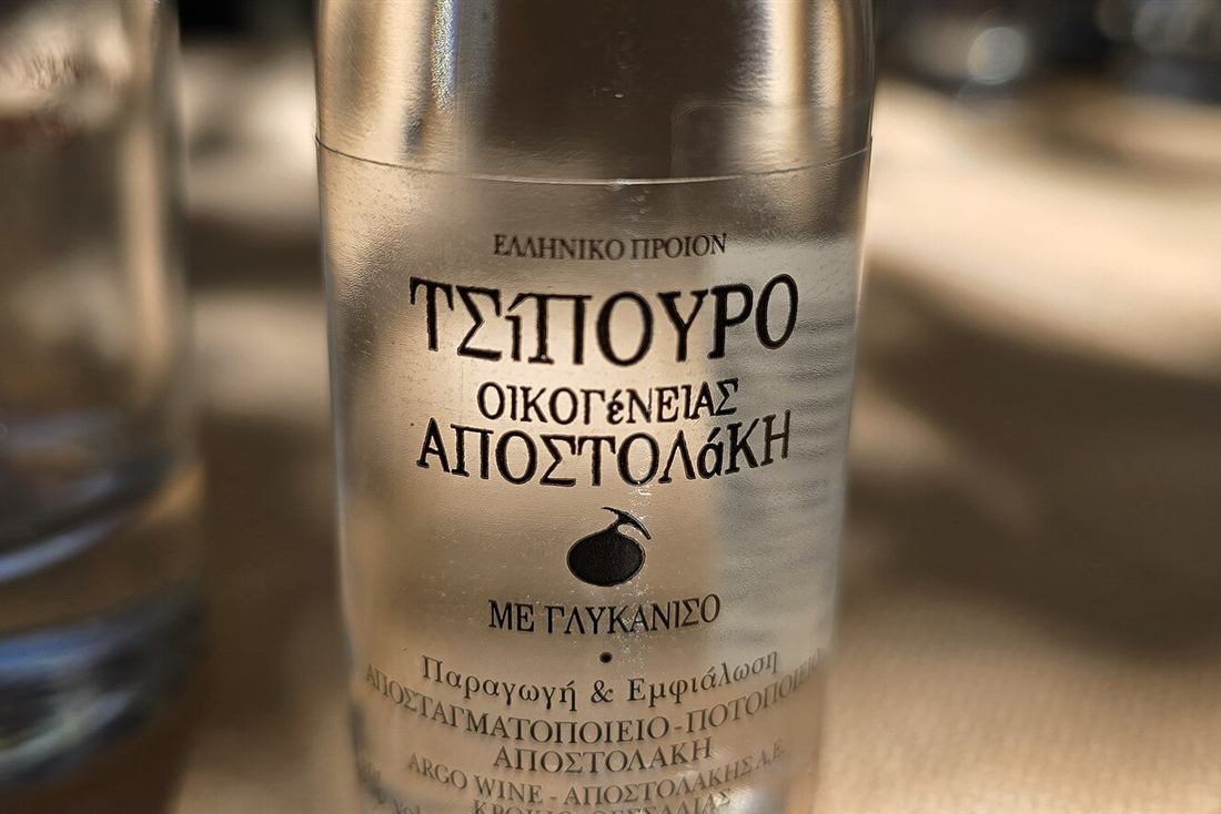 Bottle of aniseed tsipouro on a table on a Volos food tour