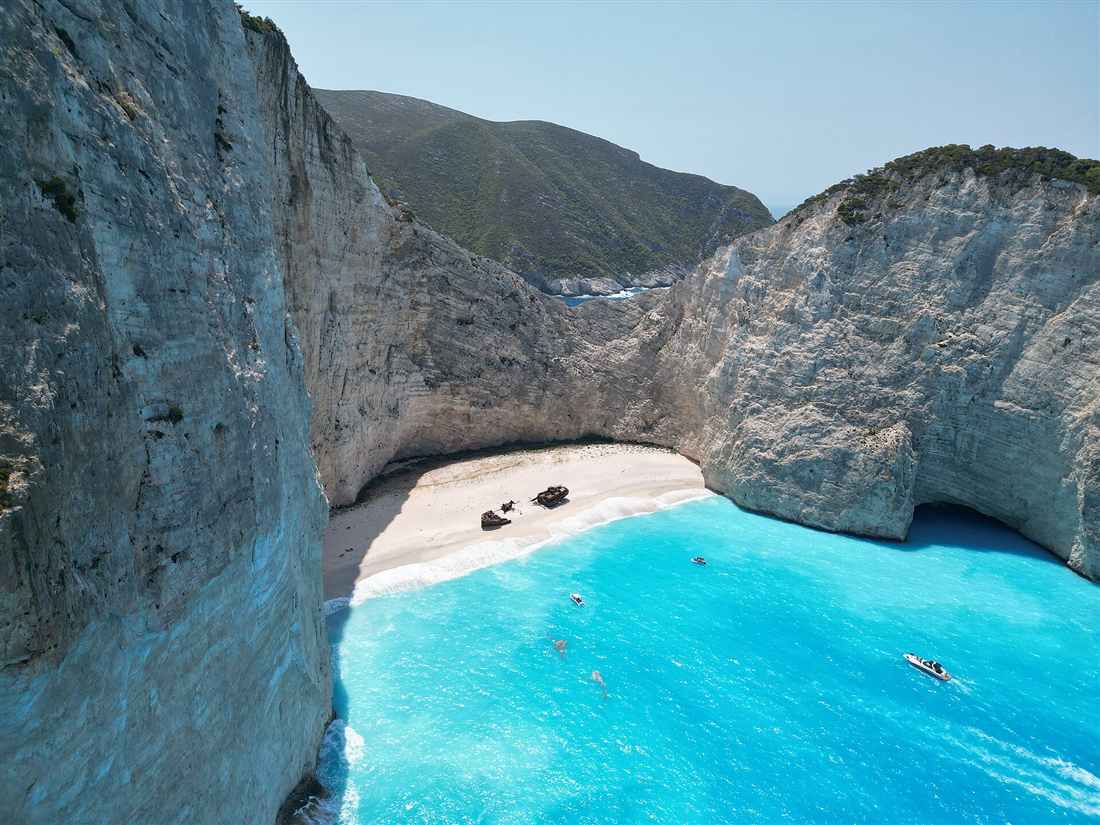 The shipwreck on Navagio Beach in its white-cliff cove on Zakynthos, the island reached by airport transfers from Zakynthos Airport