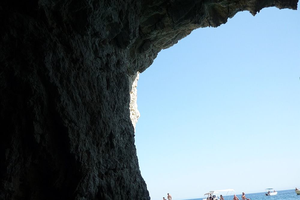 Small boats at the mouth of a Keri sea cave on Zakynthos