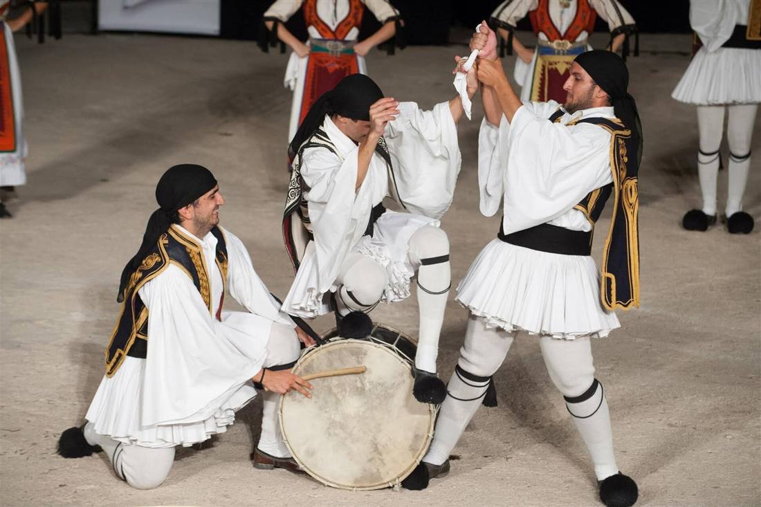 Zakynthos Greek night: folk dancers in traditional costume dancing to a drum at a Greek summer festival