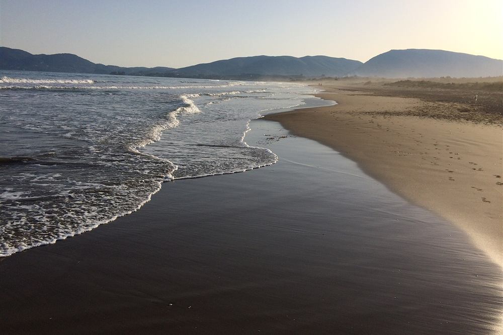 Sunset over the long sandy shore of Laganas Bay in Zakynthos, where Zakynthos horse riding routes run