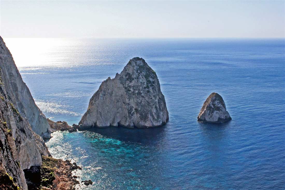 The Mizithres sea stacks below the cliffs of Keri, the viewpoint a Zakynthos off road buggy tour climbs to