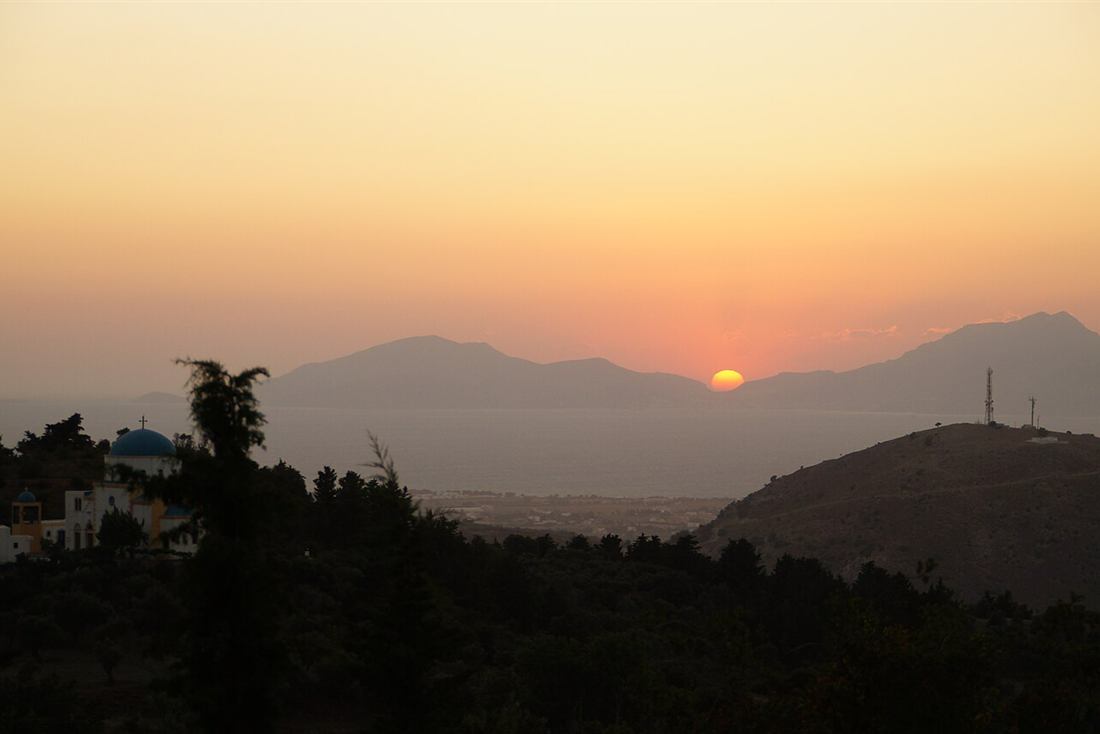The sun dropping behind Kalymnos seen from Zia village on Kos