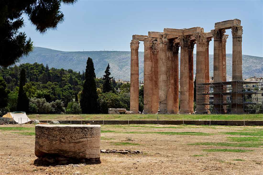 Corinthian columns of the Temple of Olympian Zeus in Athens with scaffolding on the right and a fallen drum in the foreground