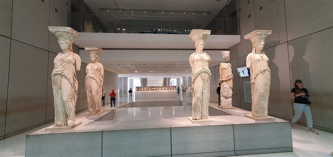 The Caryatids of the Erechtheion standing in their gallery in the Acropolis Museum, the centrepiece of an Acropolis Museum guided tour.