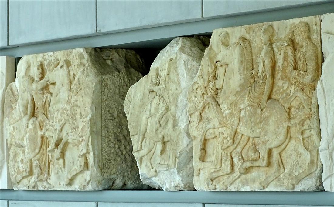 Slabs of the Parthenon frieze with horsemen in relief displayed in the Acropolis Museum, explained on an Acropolis Museum guided tour.