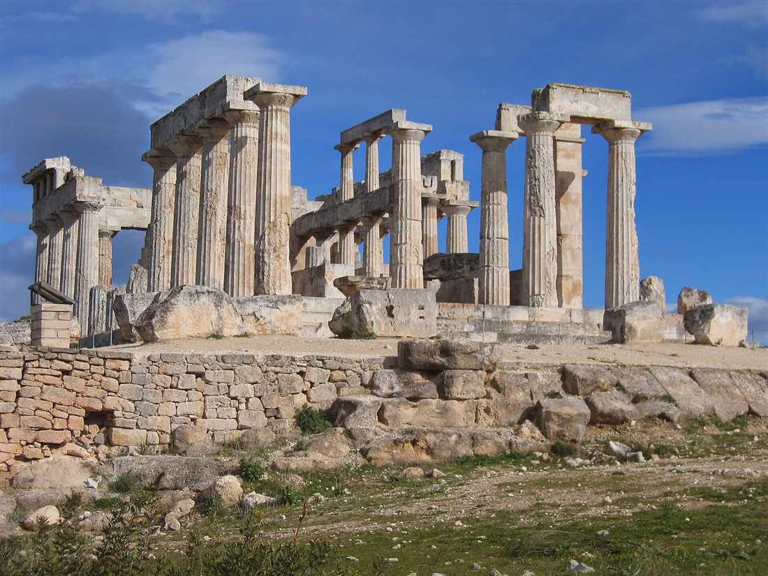 The Doric columns of the Temple of Aphaia on its hilltop on Aegina under a blue sky