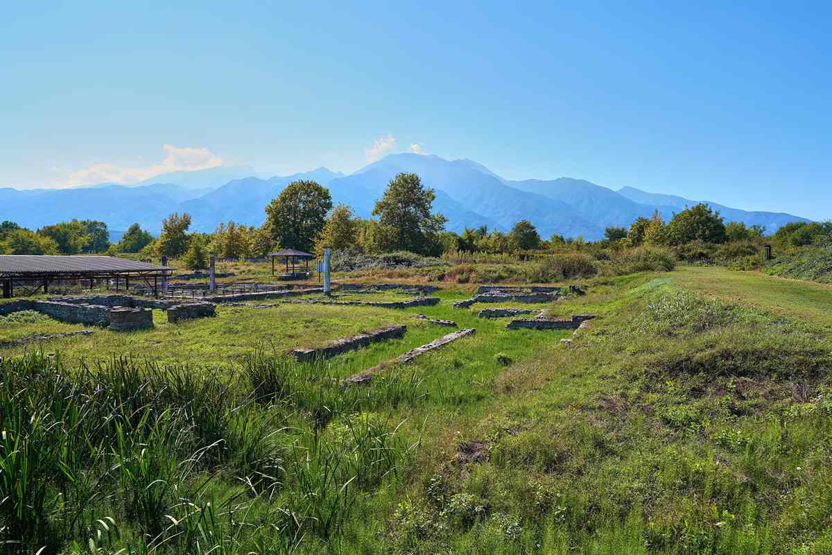 The ruins of the Villa of Dionysus spread across the grass below Mount Olympus, in the archaeological park that Ancient Dion tickets open