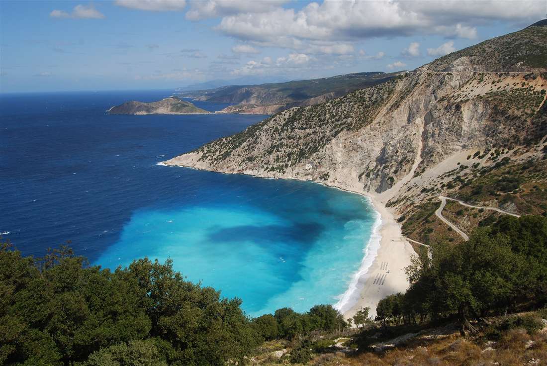 The white pebble beach and turquoise bay of Myrtos below the cliffs of north-west Kefalonia, a highlight of an Argostoli private tour.