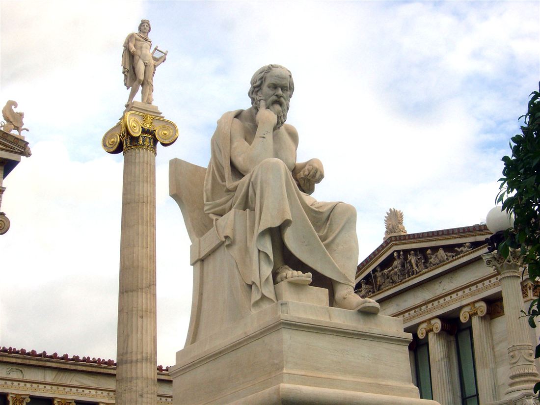The marble statue of Socrates seated in thought outside the Academy of Athens, the symbol of an Athens philosophy tour.