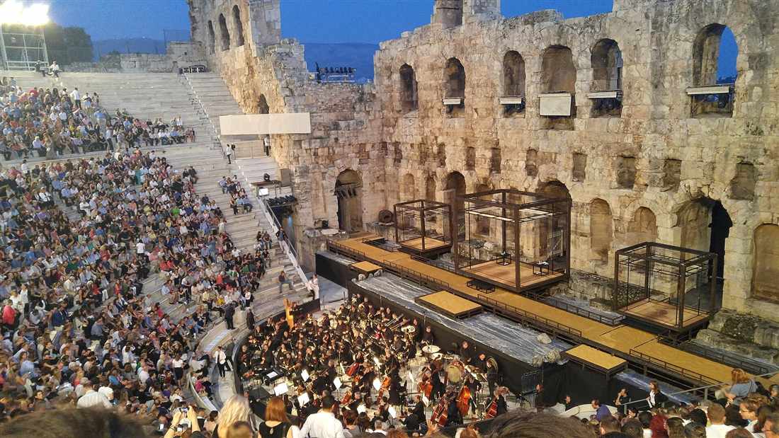 The audience filling the marble tiers of the Odeon of Herodes Atticus for an evening performance below the Acropolis, the venue of the summer Athens theater show season.