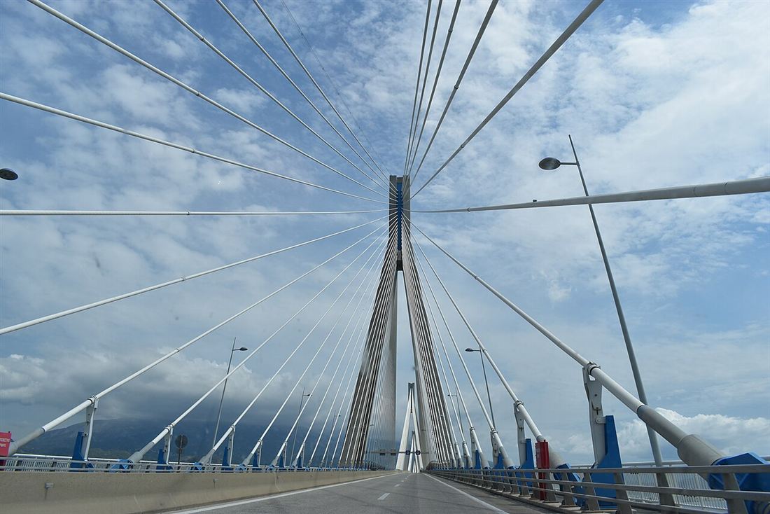 The road deck and cable pylons of the Rio–Antirrio bridge seen from a car crossing it.