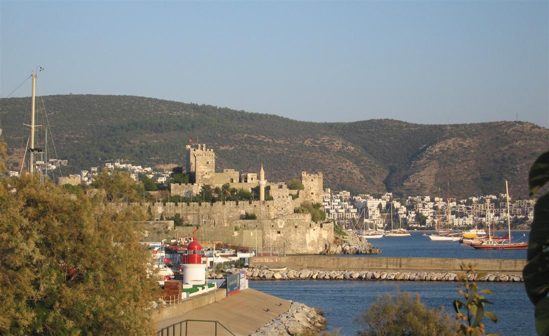 Bodrum Castle on its harbour peninsula, with yachts in the marina and the Bodrum hills behind.