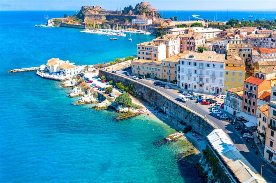 Aerial view of Corfu Old Town, the seafront road and the Old Fortress on its headland, the area a Corfu mythology tour walks.