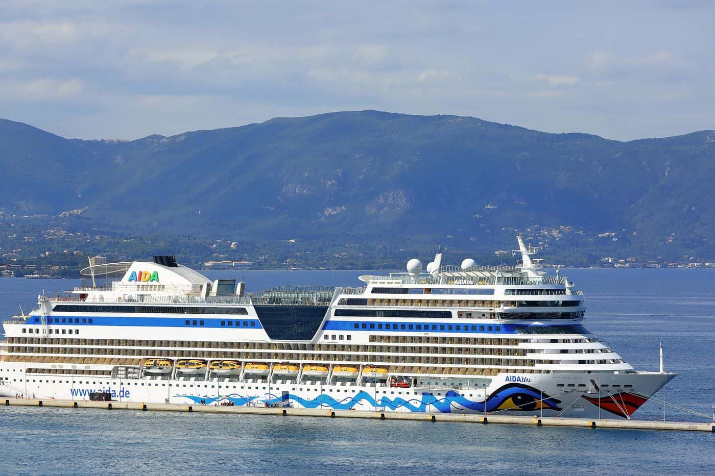 A cruise ship berthed at the port of Corfu, where Corfu port transfers meet passengers