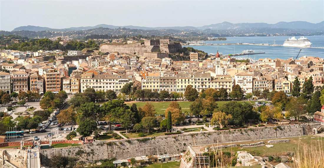 Corfu Town rooftops, the Spianada square and the New Fortress above the port on a clear day
