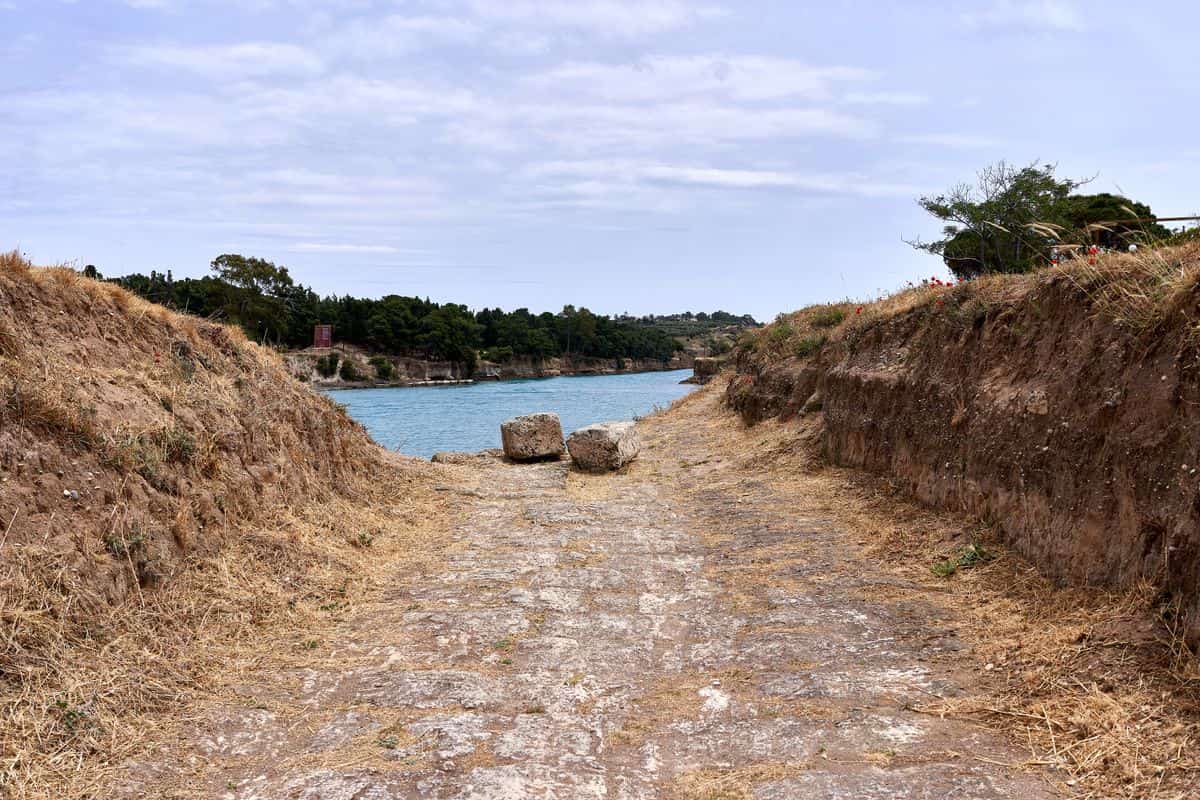 Corinth Canal tours see the excavated paved track of the ancient diolkos beside the canal