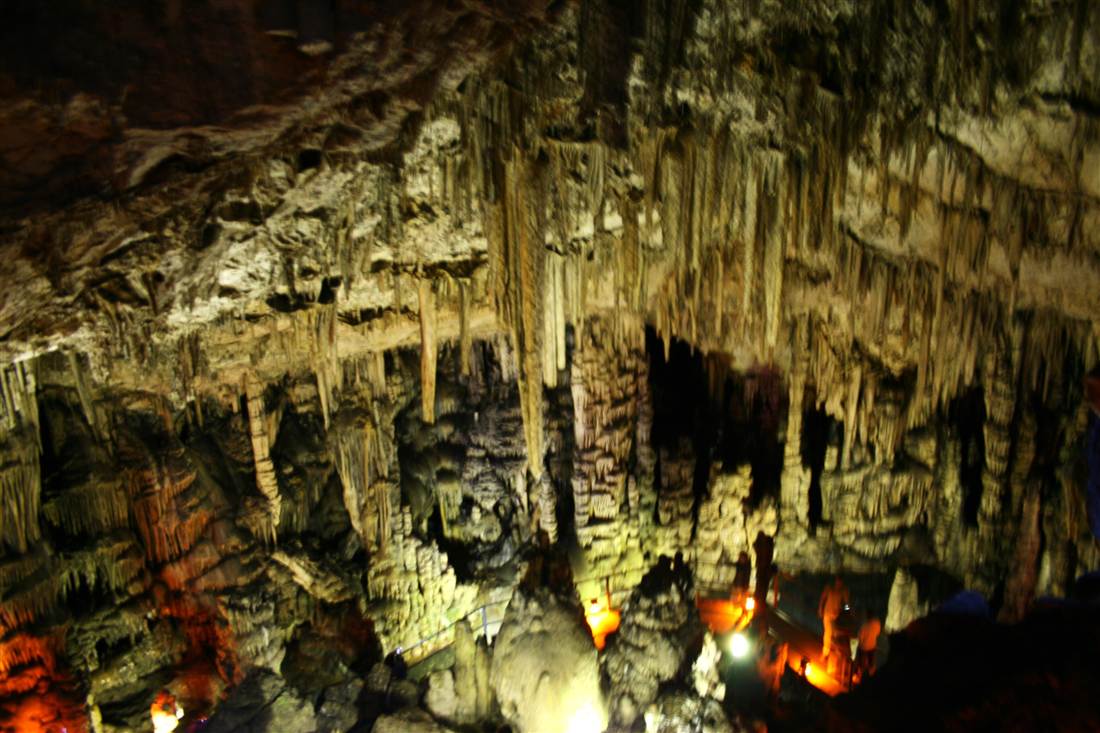 Curtains of stalactites hanging over the lit chambers of the Dikteon cave, the Cave of Zeus on a Crete cave tour.