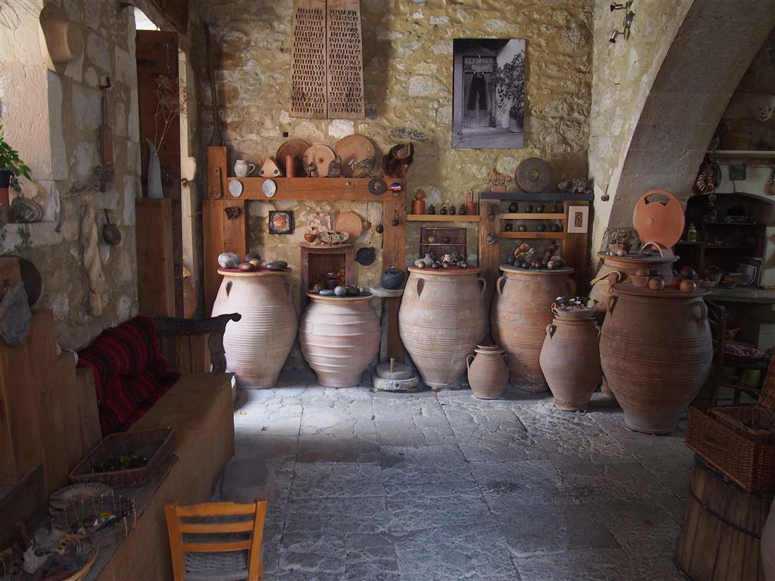Large clay pithos jars and pots in a pottery workshop in Margarites, a village where a Crete pottery class takes place.