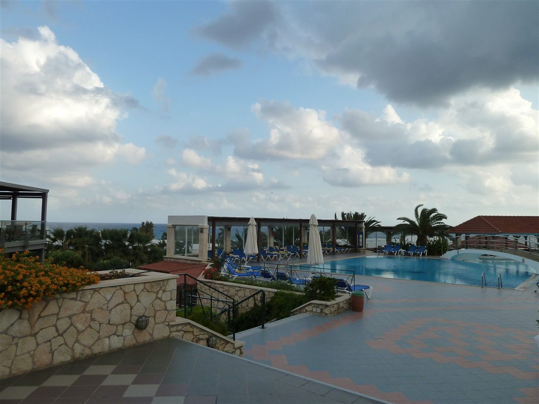 A resort pool above the sea at Hersonissos, on the coast where Crete water park tours collect their guests.