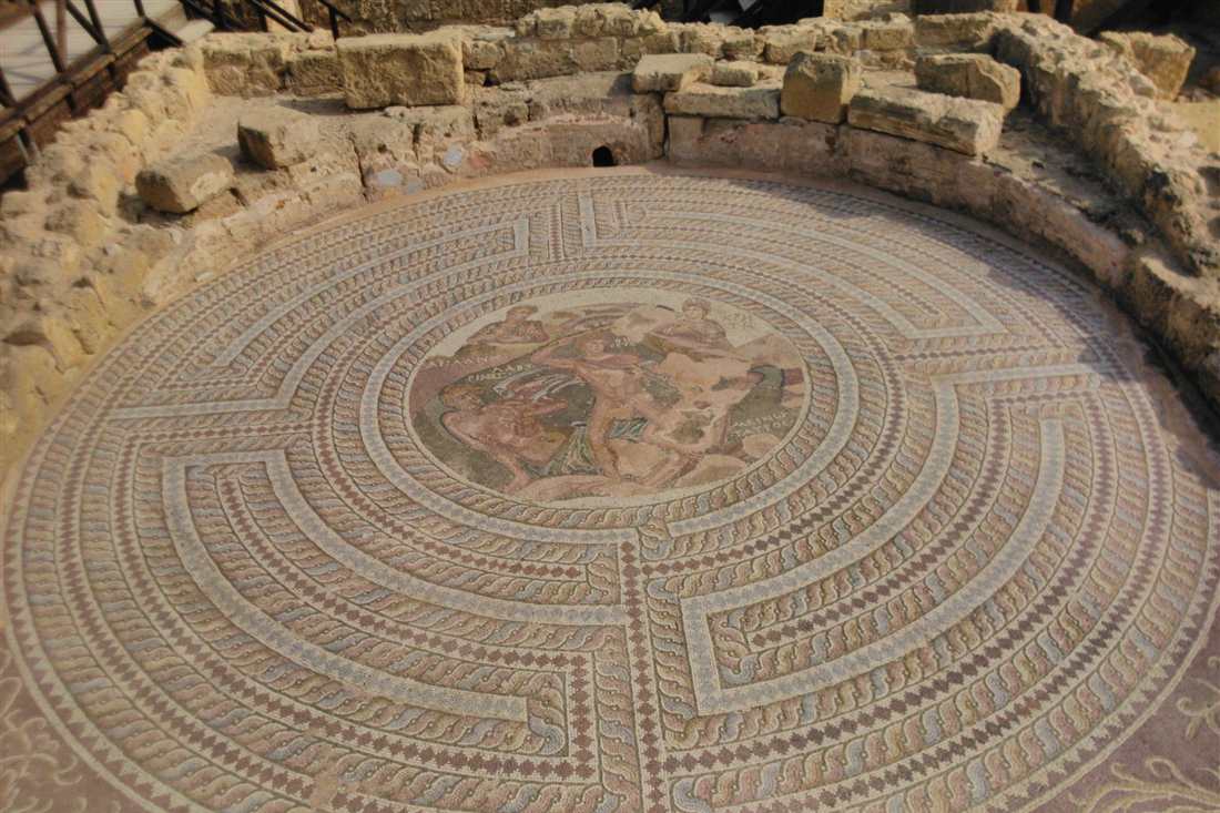 Circular Roman floor mosaic with a maze border and a central figure scene inside the Paphos Archaeological Park