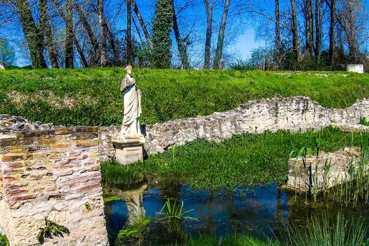 Dion tours at the Sanctuary of Isis, a marble statue above the spring-fed pool in the Dion Archaeological Park