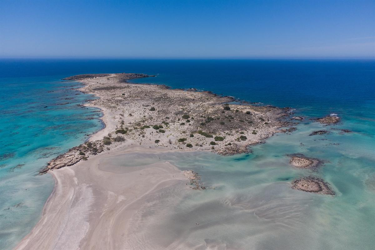 Aerial view of the Elafonisi islet, sand spit and shallow turquoise lagoon in south-west Crete, the goal of an Elafonisi day trip from Rethymno