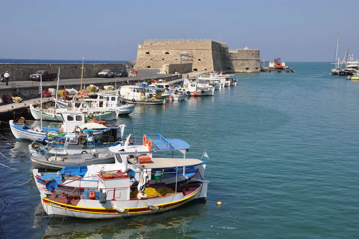 Fishing boats in the Venetian harbour of Heraklion below the Koules fortress, a stop on the Heraklion hop on hop off bus