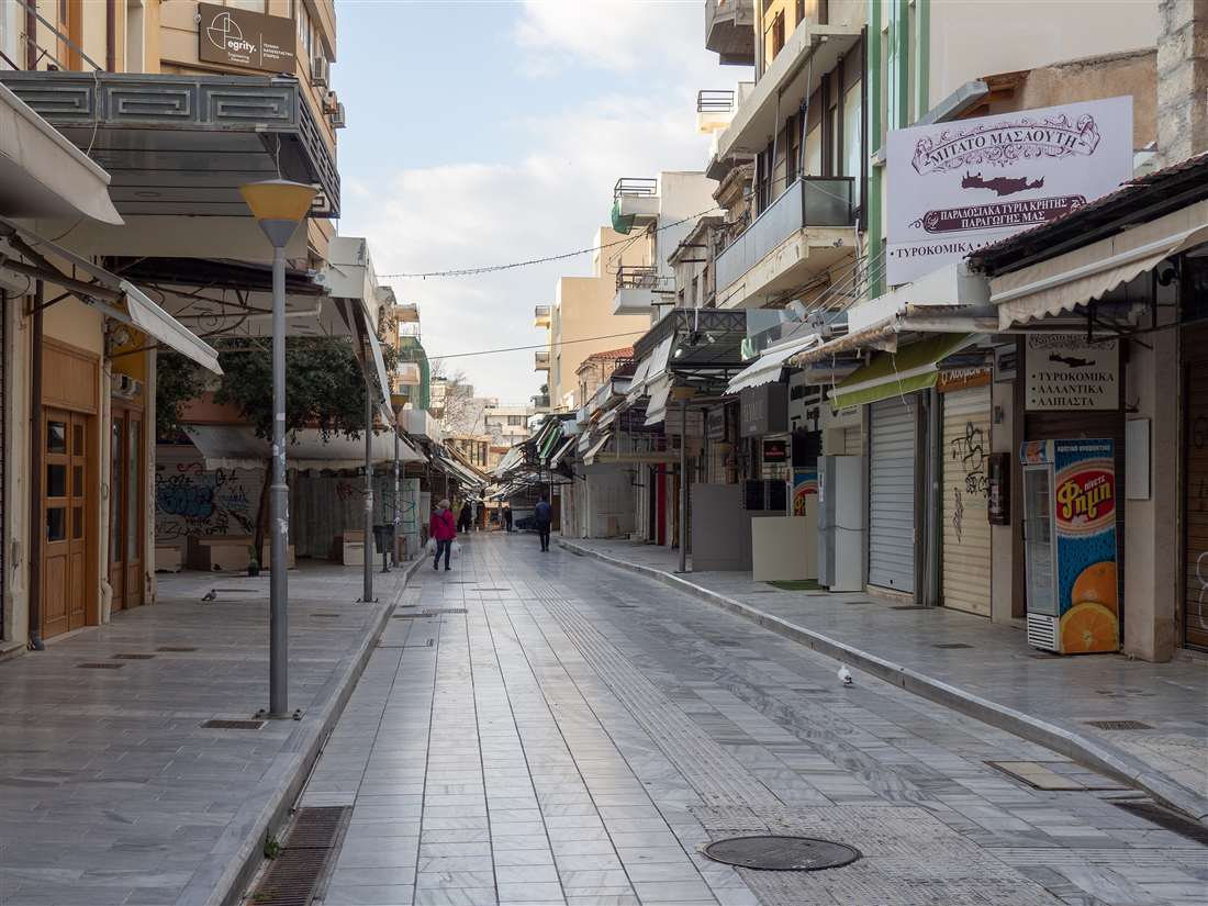 The pedestrian 1866 Street lined with shop awnings in central Heraklion, the market street walked on a Heraklion market tour.