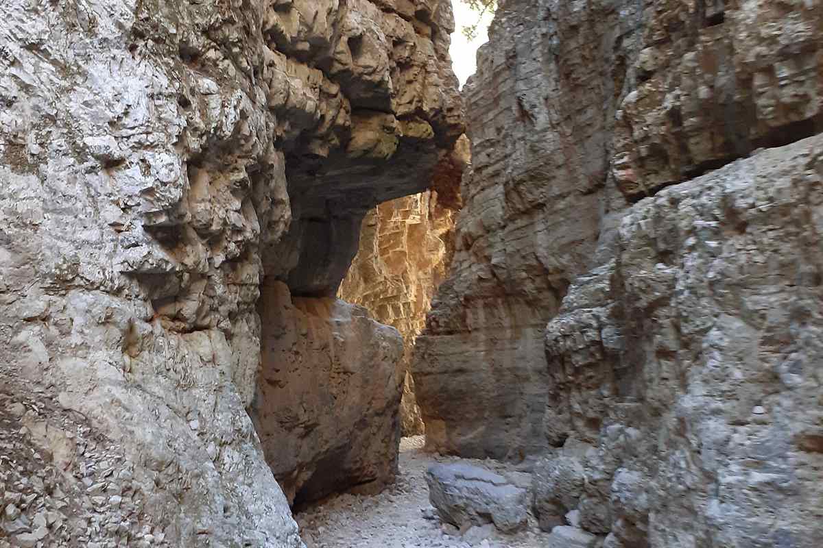 The gravel path through the narrow passage between high rock walls in the Imbros Gorge, Crete, on the walk covered by Imbros Gorge tickets