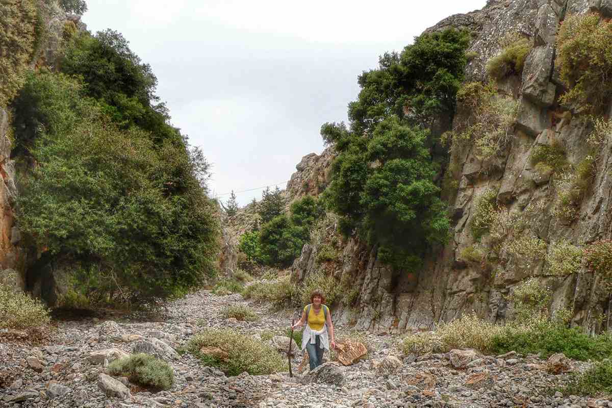 A hiker walking the stony trail along the floor of the Imbros Gorge in Crete, the route that Imbros Gorge tickets give access to