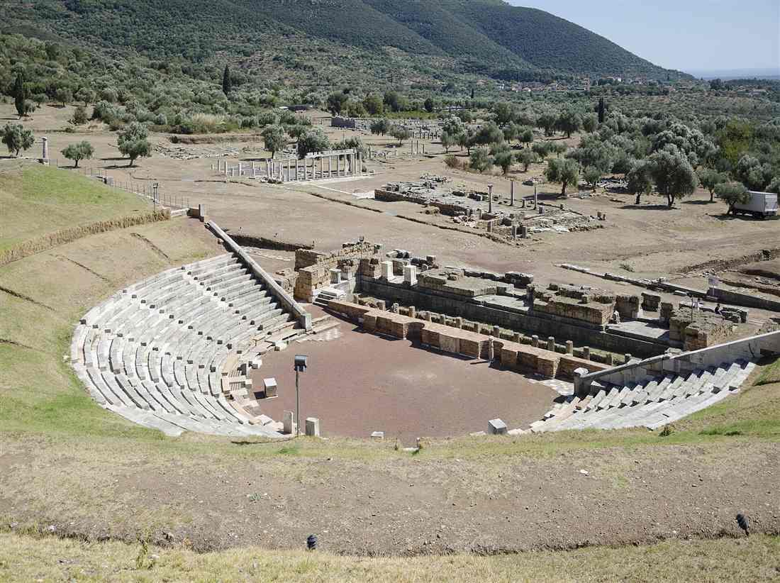 The stone theatre and the ruins of Ancient Messene among olive trees at the foot of Mount Ithome