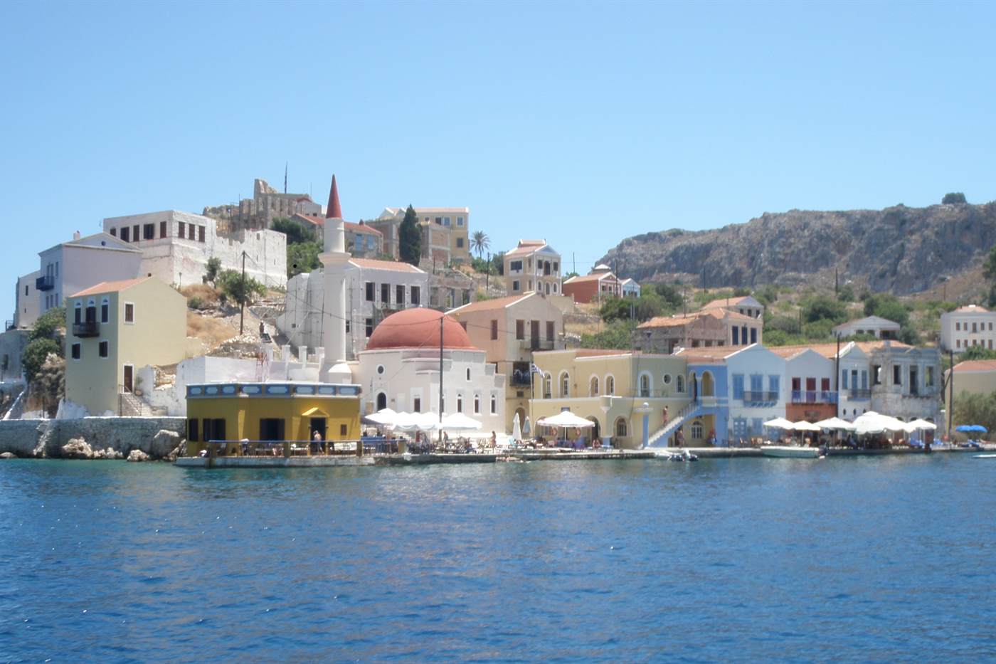 Harbour front of Megisti on Kastellorizo with its mosque and coloured neoclassical houses