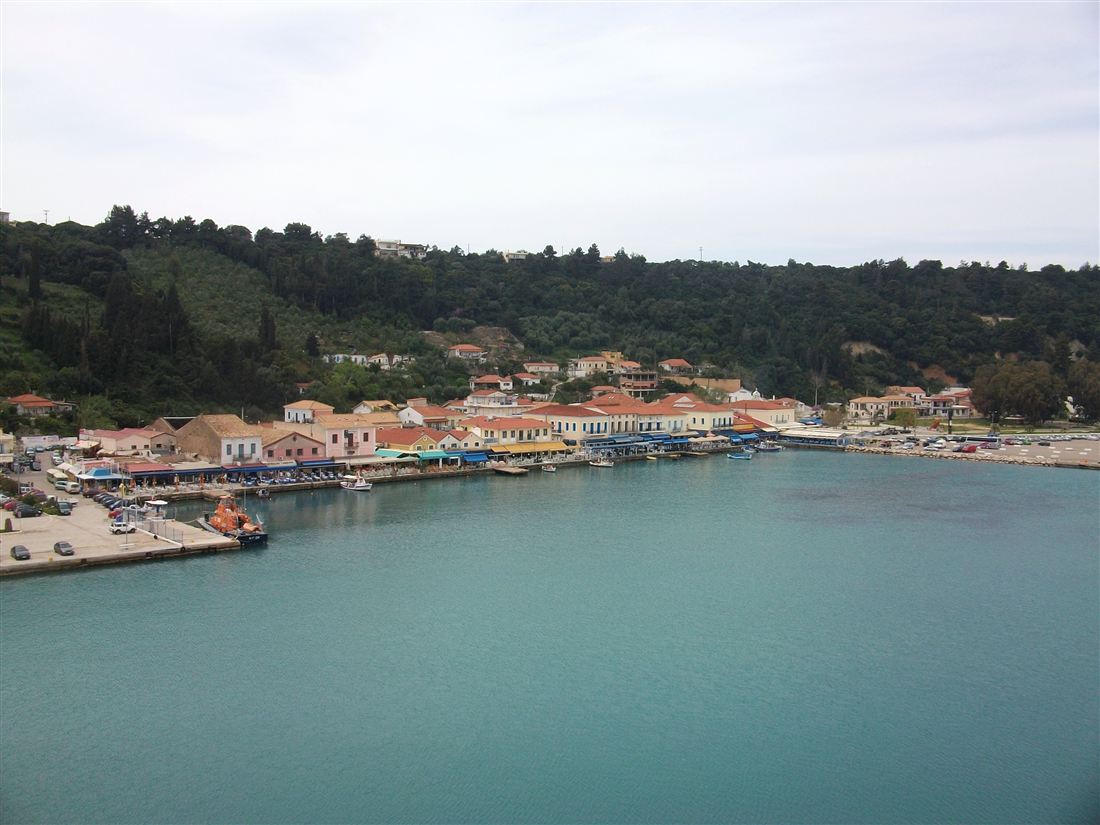 The harbour of Katakolo with its waterfront houses below green hills, the cruise port where a Katakolo wine tasting begins.
