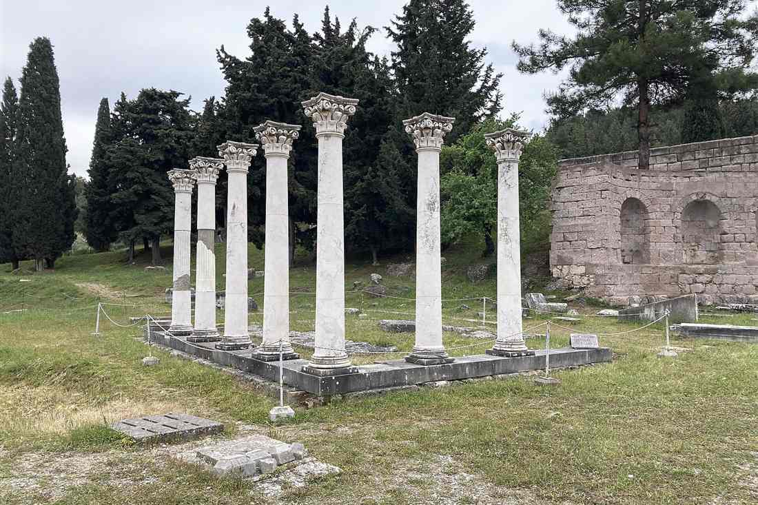 The standing Corinthian columns of the Asklepieion among cypress trees on Kos, the first stop on a Kos bus tour.