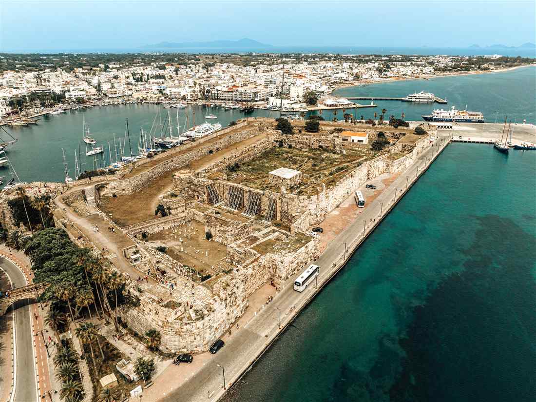 An aerial view of the Castle of the Knights (Neratzia) at the harbour of Kos town, with yachts and ferries in the port
