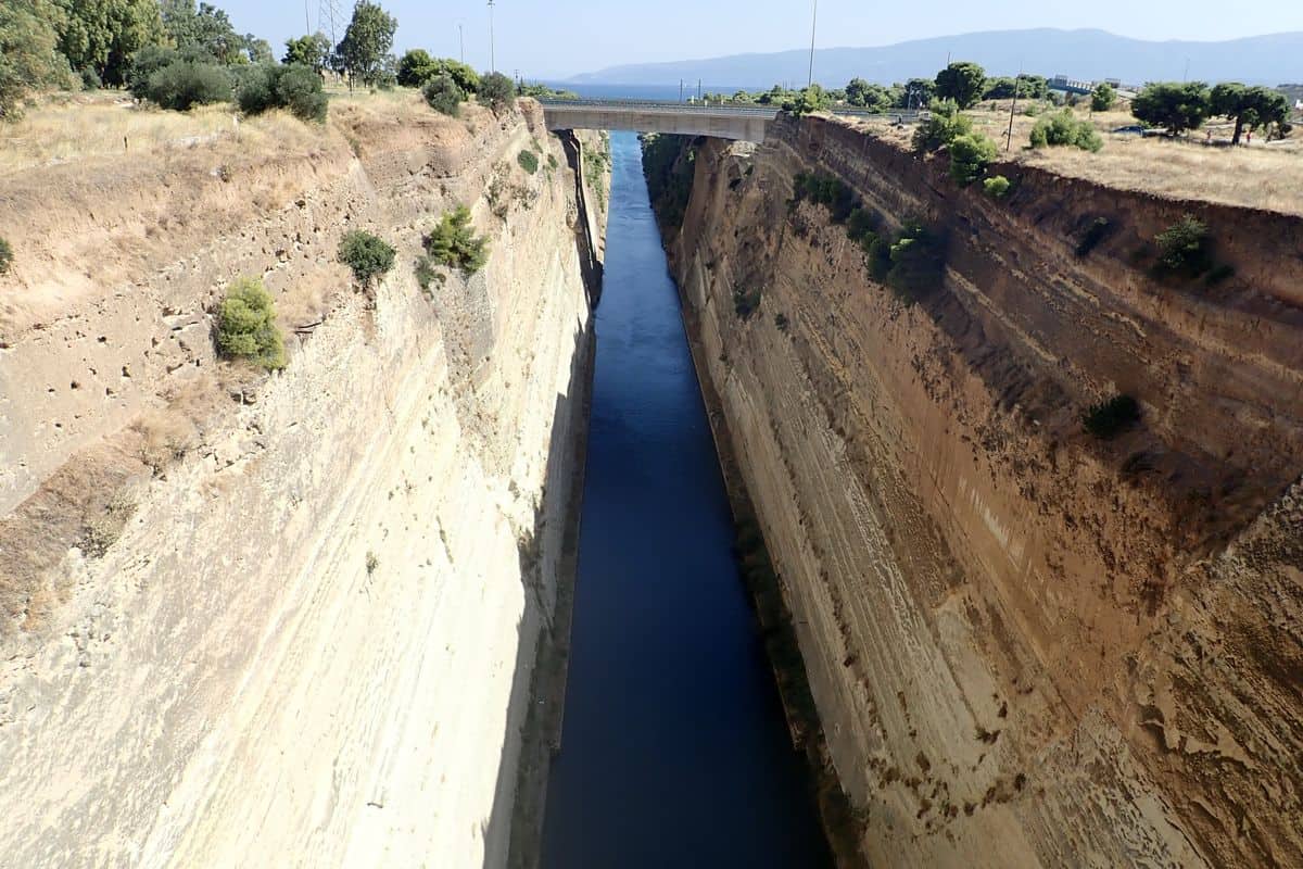 Loutraki tours look down into the Corinth Canal between its cut rock walls