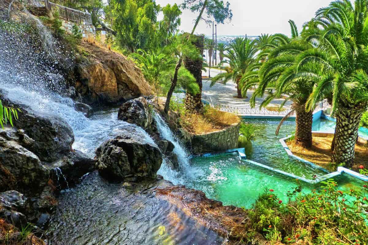 The waterfalls of the thermal spring park in Loutraki, a drop-off for Loutraki transfers