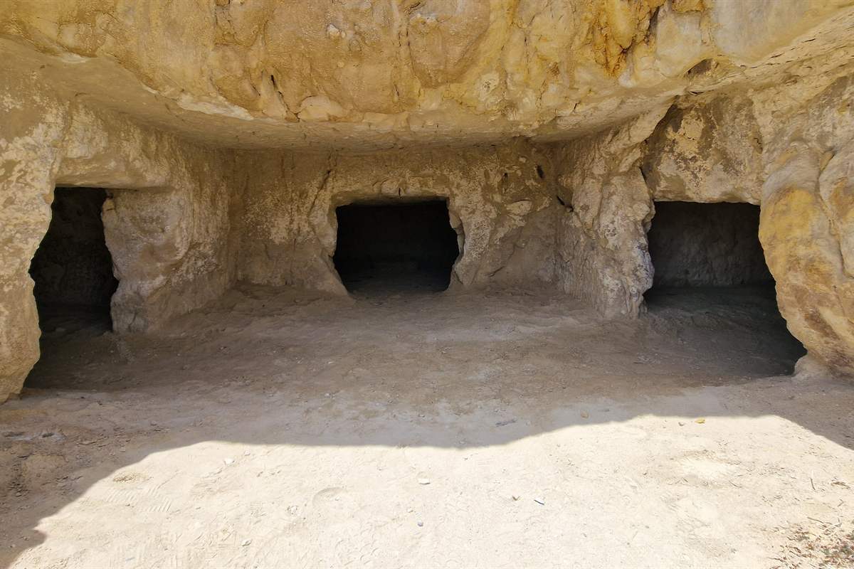 Rock-cut cave chambers in the Matala cliff, visited on a Matala day trip from Heraklion