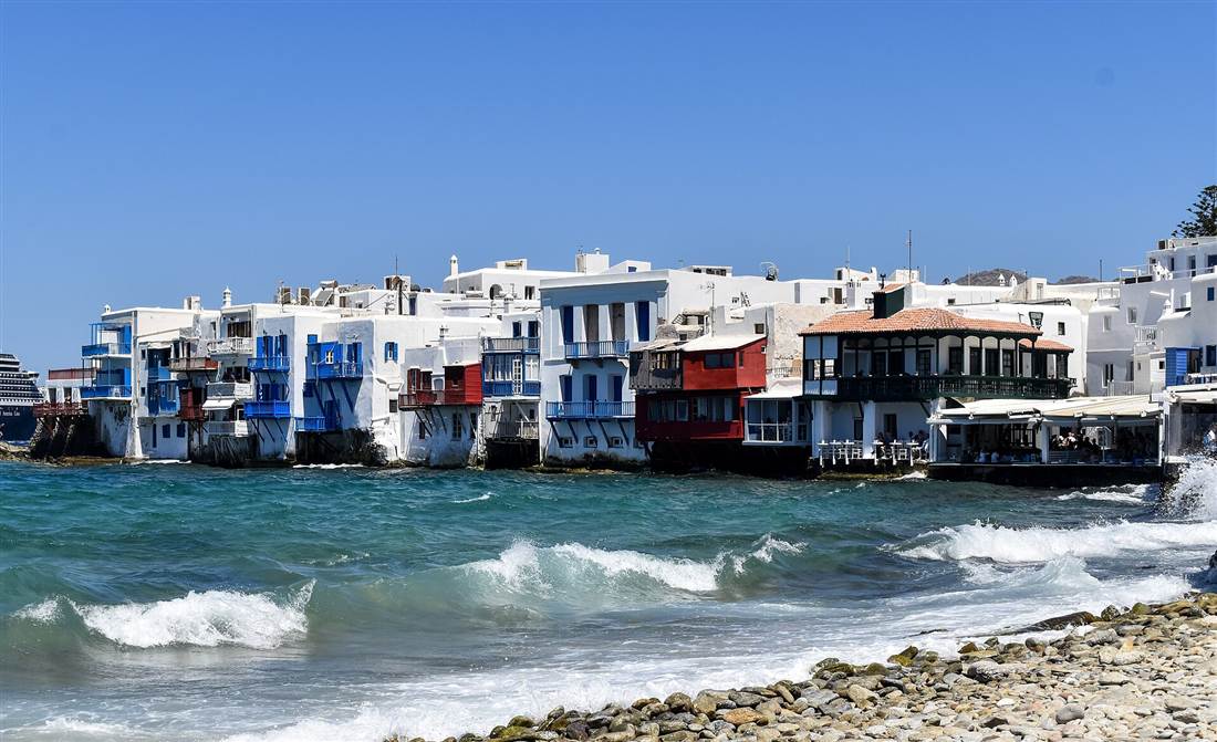 The colourful balconies of Little Venice built over the waves on the edge of Mykonos Town, where a Mykonos bus tour ends.