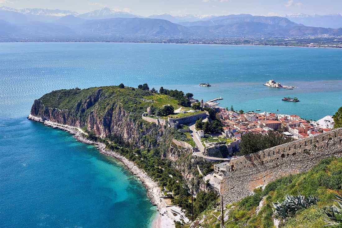 View from Palamidi over the Akronafplia headland, its coastal path and the old town of Nafplio above the blue Argolic Gulf