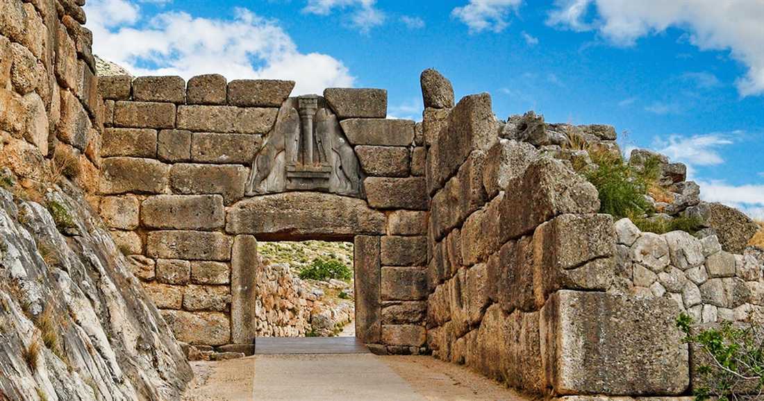 The Lion Gate of Mycenae set in walls of huge stone blocks under a blue sky, a stop on a Nafplio private tour.