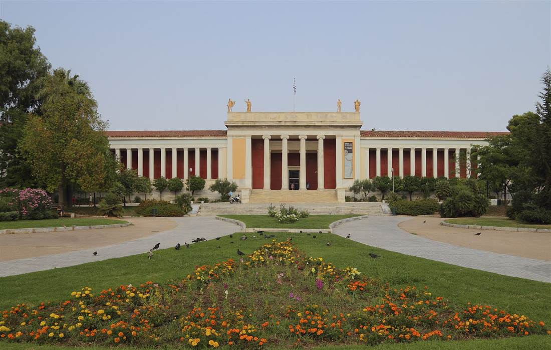 The neoclassical colonnade and red facade of the National Archaeological Museum on Patission Street in Athens, the entrance for visitors holding National Archaeological Museum tickets.