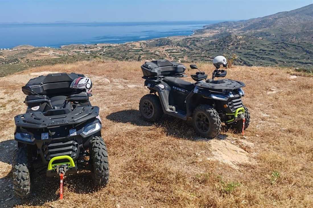 Two quad bikes parked on a dry hilltop track high above the sea on a Naxos ATV tour.