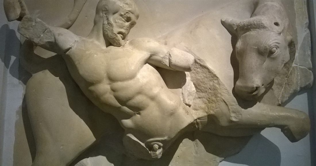 A marble metope from the Temple of Zeus at Olympia showing Heracles wrestling the Cretan bull.