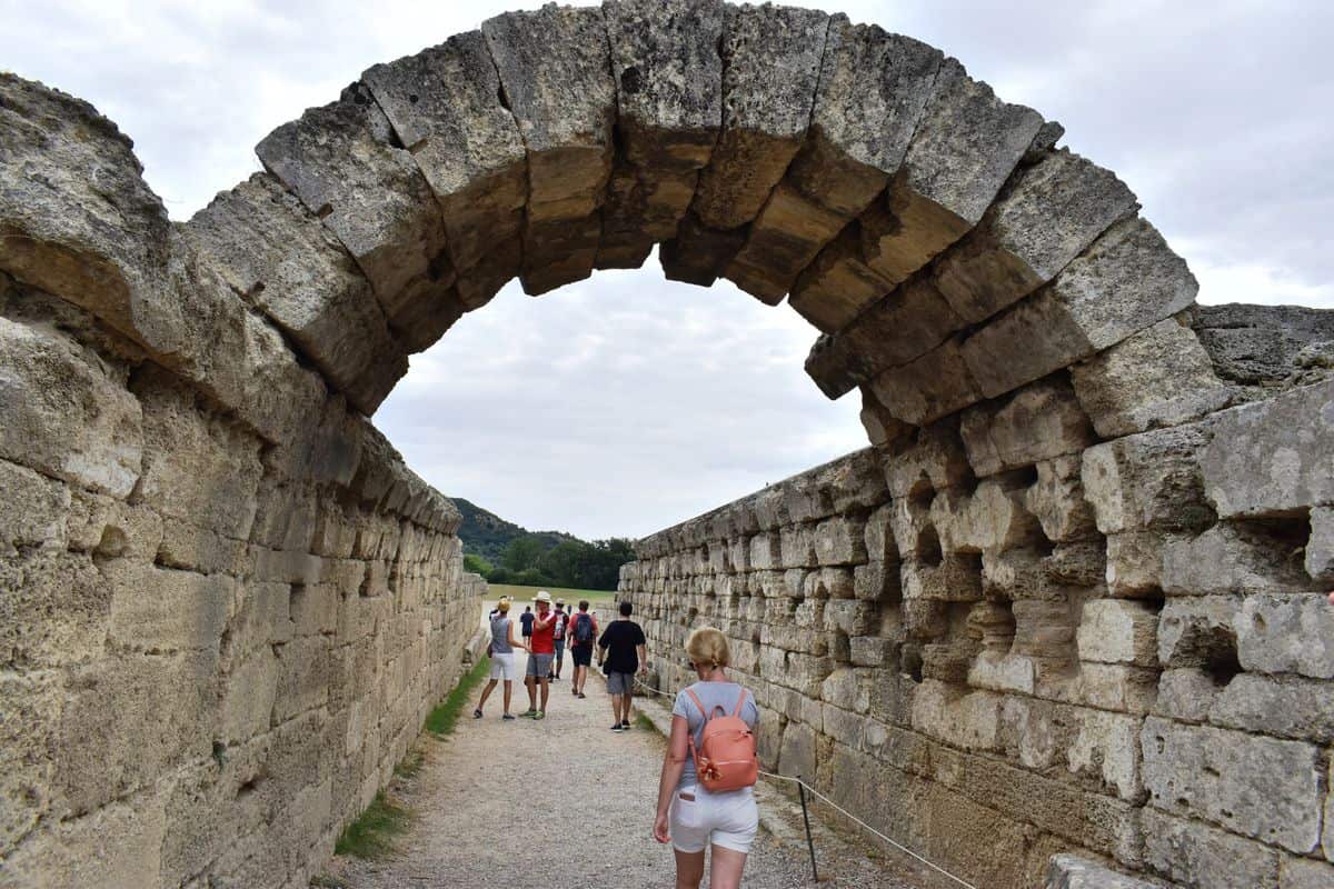 Olympia VR tour visitors at the vaulted entrance of the ancient stadium