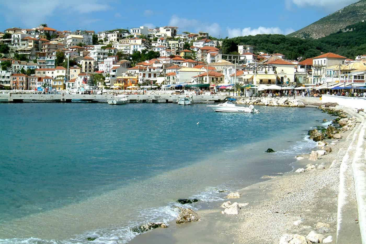 Parga tours along the town beach with the houses of Parga rising above the turquoise bay