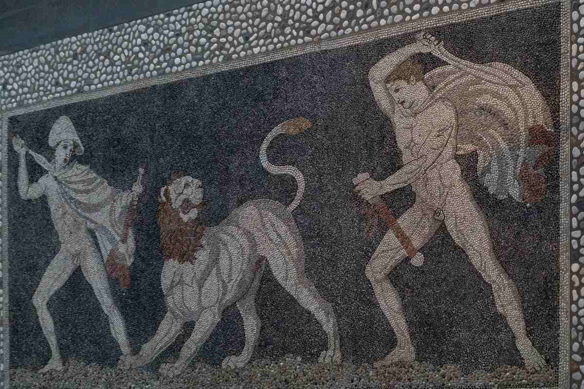 Two hunters attack a lion in the pebble mosaic from the House of Dionysos, a highlight of the museum that Pella tickets open