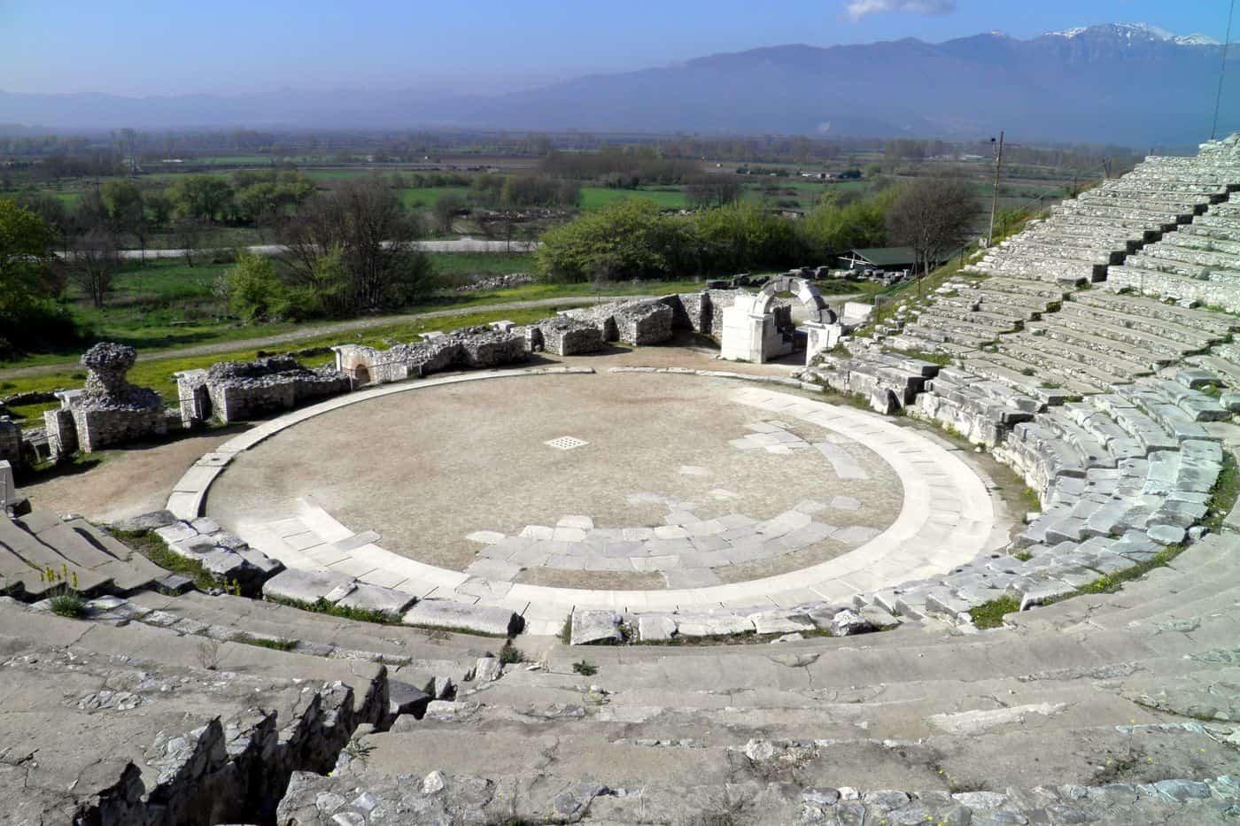 Philippi tours at the ancient theatre of Philippi, with the orchestra, the stone seats and the plain beyond