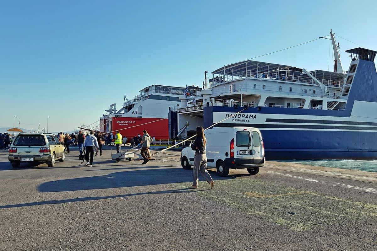 Passengers and cars beside a ferry on the quay of Rafina port, the pickup point for Rafina port transfers